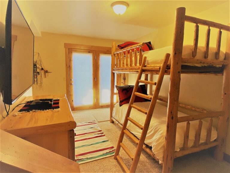 Whitefish lake vacation rental bunk bed room with large tv.